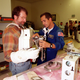 KENNEDY SPACE CENTER, FLA. -- Astronaut John Herrington (right) helps Norm Abram try on a tool carrier used in space. Abram is the master carpenter on television’s "This Old House." He is at KSC to film an episode of the series